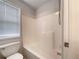 Clean bathroom highlighting a toilet with window and a shower/tub combination with a shower head at 6001 Deer Springs Nw Ln, Acworth, GA 30101
