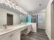 Modern bathroom featuring a double vanity, frameless shower, and updated fixtures at 6001 Deer Springs Nw Ln, Acworth, GA 30101
