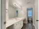 Bright bathroom with a large mirror, vanity with white cabinets, and view into the water closet at 6001 Deer Springs Nw Ln, Acworth, GA 30101