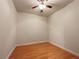 Empty bedroom with hardwood floors, a ceiling fan, and natural light from an unseen window at 6001 Deer Springs Nw Ln, Acworth, GA 30101
