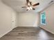 Bright bedroom features wood-look floors, a ceiling fan, and a window providing natural light at 6001 Deer Springs Nw Ln, Acworth, GA 30101