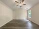 Bright bedroom featuring vaulted ceiling with fan and a window overlooking the well-manicured lawn at 6001 Deer Springs Nw Ln, Acworth, GA 30101