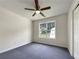 Cozy bedroom featuring a ceiling fan and a bright window overlooking the well-manicured lawn at 6001 Deer Springs Nw Ln, Acworth, GA 30101