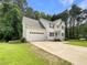 Charming two-story home with white siding, attached garage, and a well-manicured front lawn at 6001 Deer Springs Nw Ln, Acworth, GA 30101