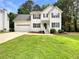 Charming two-story home featuring a well-manicured lawn, attached garage, and traditional architectural details at 6001 Deer Springs Nw Ln, Acworth, GA 30101