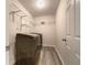 Laundry room featuring a washer, dryer, metal racks, and a white door at 6001 Deer Springs Nw Ln, Acworth, GA 30101