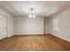Bright living room featuring hardwood floors, a modern light fixture, and wainscoting detail at 6001 Deer Springs Nw Ln, Acworth, GA 30101