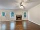 Spacious living room with hardwood floors, fireplace, ceiling fan, and lots of natural light at 6001 Deer Springs Nw Ln, Acworth, GA 30101