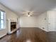 Bright living room featuring hardwood floors, a fireplace with stonework, and natural light at 6001 Deer Springs Nw Ln, Acworth, GA 30101