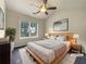 Serene main bedroom with vaulted ceilings, a ceiling fan, a neutral color palette, and natural light at 6001 Deer Springs Nw Ln, Acworth, GA 30101