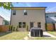 Exterior view of home with a grill and a well maintained fenced-in backyard at 104 Auburn Crossing Way, Auburn, GA 30011