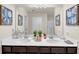 Elegant bathroom boasting a double vanity with a large mirror and decorative artwork at 104 Auburn Crossing Way, Auburn, GA 30011