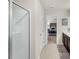 Bright bathroom featuring a glass shower and a view into an adjacent bedroom at 104 Auburn Crossing Way, Auburn, GA 30011