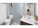 Clean and bright bathroom with a vanity, toilet, and shower, with a playful art print on the wall at 104 Auburn Crossing Way, Auburn, GA 30011