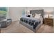 Comfortable bedroom features a large bed, a cozy chair, and natural light, creating a relaxing and inviting atmosphere at 104 Auburn Crossing Way, Auburn, GA 30011