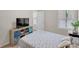 Cozy bedroom with a comfortable bed, a TV, storage, and natural light, creating a relaxing and inviting space at 104 Auburn Crossing Way, Auburn, GA 30011
