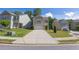 Charming two-story home with a stone-accented facade, well-manicured lawn, and a concrete driveway at 104 Auburn Crossing Way, Auburn, GA 30011