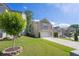Attractive two-story home featuring manicured lawn, concrete driveway, and established landscaping at 104 Auburn Crossing Way, Auburn, GA 30011