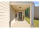 Welcoming covered porch with brick accents and a stylish front door, perfect for relaxing at 104 Auburn Crossing Way, Auburn, GA 30011