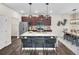 Modern kitchen with stainless steel appliances, island with seating, and sleek countertops at 104 Auburn Crossing Way, Auburn, GA 30011