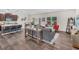 Bright and airy living room with wood floors seamlessly connecting to the dining and kitchen areas at 104 Auburn Crossing Way, Auburn, GA 30011