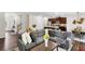 Open-concept living area with hardwood floors, kitchen with island, and a spacious seating arrangement at 104 Auburn Crossing Way, Auburn, GA 30011
