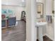Bright powder room with a pedestal sink and decorative mirror conveniently located near the living area at 104 Auburn Crossing Way, Auburn, GA 30011