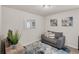 Well-lit sitting room with a comfortable sofa and tasteful wall art at 104 Auburn Crossing Way, Auburn, GA 30011