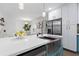 Bright kitchen boasts stainless steel appliances, farmhouse sink, and white quartz countertops at 1643 Flintwood Se Dr, Atlanta, GA 30316
