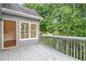 Private back deck with wooded views offers a peaceful retreat connected to the home at 200 Ridge Bluff Ln, Suwanee, GA 30024
