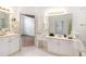 Spacious bathroom with dual sinks, white cabinets, gold fixtures, and ample counter space at 200 Ridge Bluff Ln, Suwanee, GA 30024