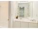 Clean bathroom featuring a large mirror, vanity with storage, and tub with shower at 200 Ridge Bluff Ln, Suwanee, GA 30024