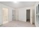 Neutral bedroom featuring carpeting, white walls, and access to an en-suite bathroom and closet at 200 Ridge Bluff Ln, Suwanee, GA 30024