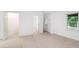 Bright bedroom with neutral carpeting, white walls, and a closet provides a relaxing space at 200 Ridge Bluff Ln, Suwanee, GA 30024