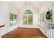 Bright breakfast nook featuring a vaulted ceiling, wood floors, and a door to the deck at 200 Ridge Bluff Ln, Suwanee, GA 30024