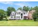 Two story home with a lush green lawn and well maintained landscaping at 200 Ridge Bluff Ln, Suwanee, GA 30024