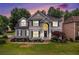 Charming two-story home featuring a manicured lawn and classic architectural details at 200 Ridge Bluff Ln, Suwanee, GA 30024