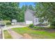 Side view of home showcasing the two car garage and landscaping at 200 Ridge Bluff Ln, Suwanee, GA 30024