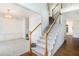 Bright foyer featuring wood floors, a staircase with white railings, and elegant trim work at 200 Ridge Bluff Ln, Suwanee, GA 30024