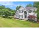 Charming two story home with a manicured lawn, mature trees, and detailed landscaping at 200 Ridge Bluff Ln, Suwanee, GA 30024