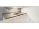 Functional kitchenette featuring granite counters, ample storage, and tiled backsplash at 200 Ridge Bluff Ln, Suwanee, GA 30024