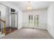 Bright living room featuring plush carpeting, elegant trim, and a statement lighting fixture at 200 Ridge Bluff Ln, Suwanee, GA 30024