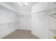 Bright walk-in closet featuring sturdy wire shelving and neutral carpeting for organized storage at 200 Ridge Bluff Ln, Suwanee, GA 30024
