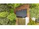 Aerial view of a house with a dark roof, green lawn, and a newly paved driveway at 2798 Hutchins Rd, Lawrenceville, GA 30044