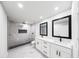 Modern bathroom with a walk-in shower, dual vanity sinks, and elegant marble-look tile at 2798 Hutchins Rd, Lawrenceville, GA 30044