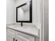 Stylish bathroom with white marble countertop, black faucet, and a framed mirror at 2798 Hutchins Rd, Lawrenceville, GA 30044