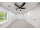 Spacious bedroom featuring neutral walls, carpet, ceiling fan, and natural light from the windows at 2798 Hutchins Rd, Lawrenceville, GA 30044