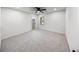 Bright bedroom featuring neutral walls, carpet, ceiling fan, and a convenient closet space at 2798 Hutchins Rd, Lawrenceville, GA 30044
