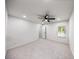 Spacious bedroom featuring a ceiling fan, neutral walls, plush carpet, and natural light at 2798 Hutchins Rd, Lawrenceville, GA 30044