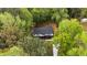 Aerial image of a light colored home surrounded by a lush forest, with a driveway at 2798 Hutchins Rd, Lawrenceville, GA 30044
